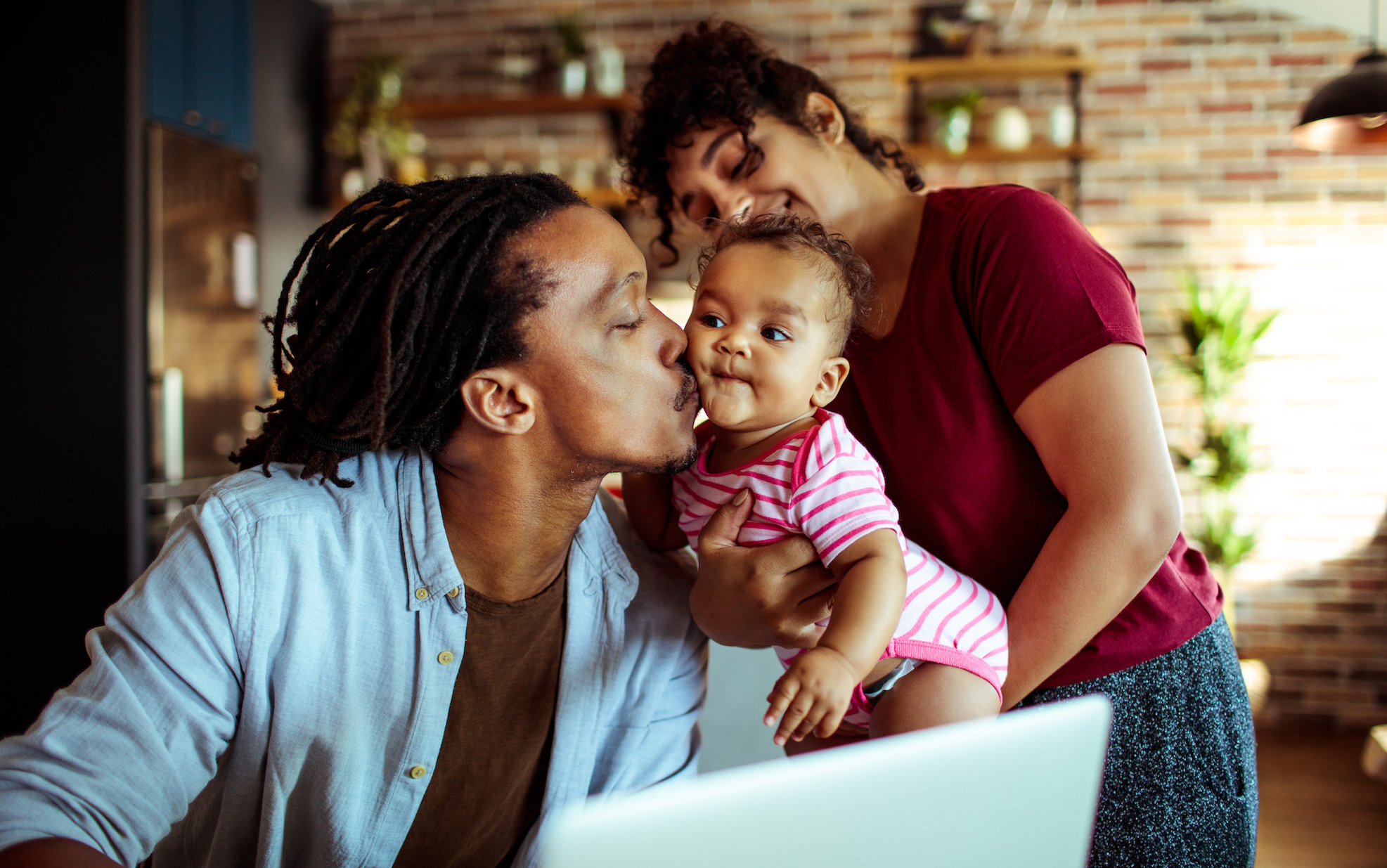 2022 Insurance Barometer Study finds life insurance provides a pathway to financial security Young Black family using laptop