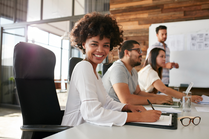 Young african woman sitting at a business presentation